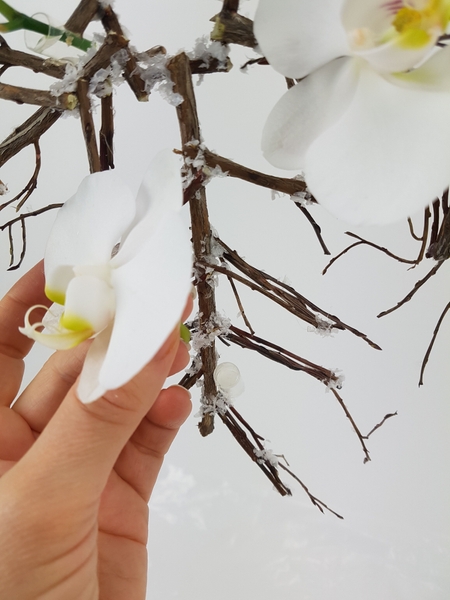 Glue in tiny water tubes to keep the fresh flowers hydrated