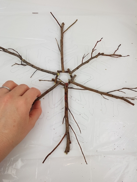 Match the natural shape of the twigs to the snowflake pattern Match the natural shape of the twigs to the snowflake pattern