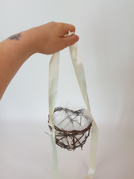 Adjust the ribbon to the length you want the handle to be. Adjust the ribbon to the length you want the handle to be.