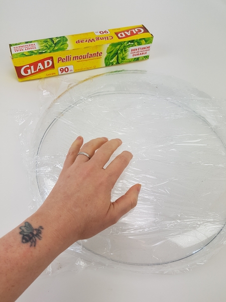 Cover a shallow container with plastic wrap Cover a shallow container with plastic wrap