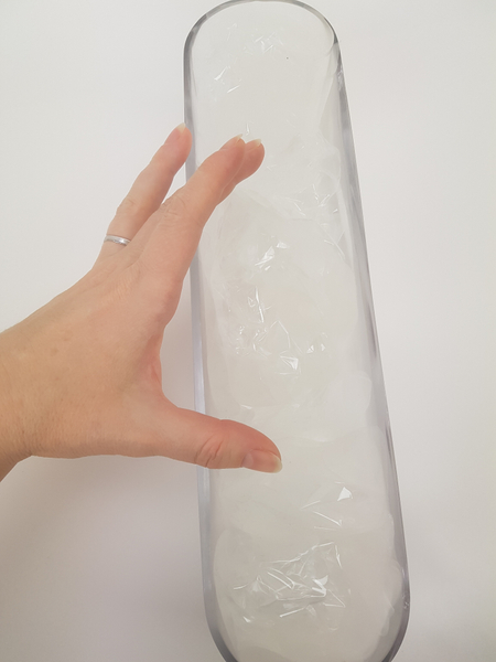 Fill the container from the one end to the other with upright cellophane folds