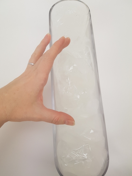 Fill the container from the one end to the other with upright cellophane folds Fill the container from the one end to the other with upright cellophane folds