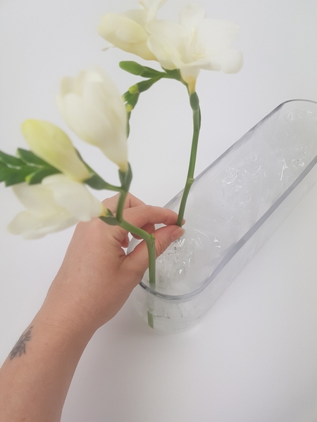 Place the flower stems to stand upright in the folds Place the flower stems to stand upright in the folds