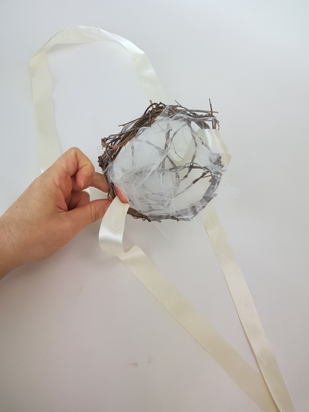 Thread the ribbon through the basket to create a luxurious handle Thread the ribbon through the basket to create a luxurious handle