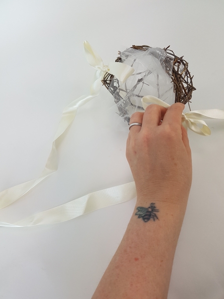 You can let the ribbon ends dangle or tie it into a bow. You can let the ribbon ends dangle or tie it into a bow.