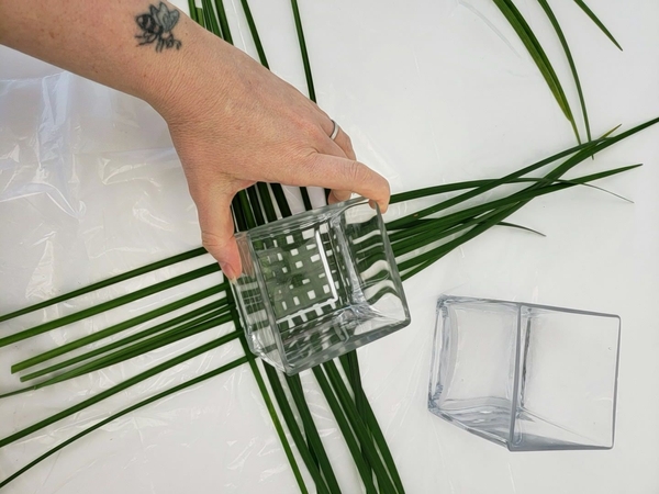 Place the small container on the woven grass Place the small container on the woven grass