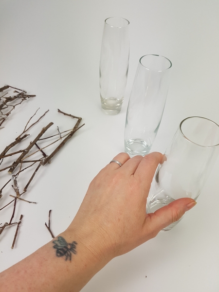 Place three bud vases on a working surface