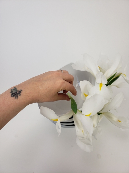 Set the top flower to rest in the water Set the top flower to rest in the water