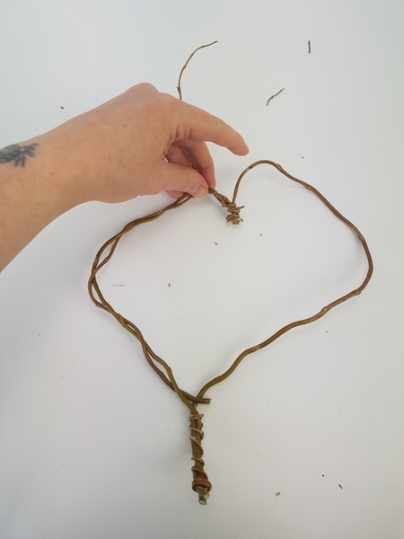 Weave a few stems around this shape to make it strong Weave a few stems around this shape to make it strong