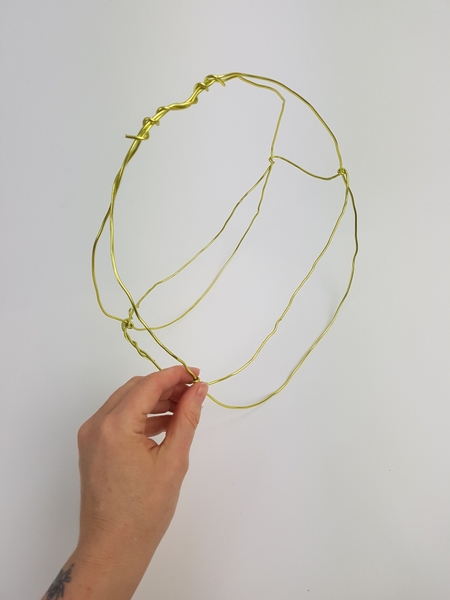 Add another length of wire horizontally around the basket to create the sides Add another length of wire horizontally around the basket to create the sides