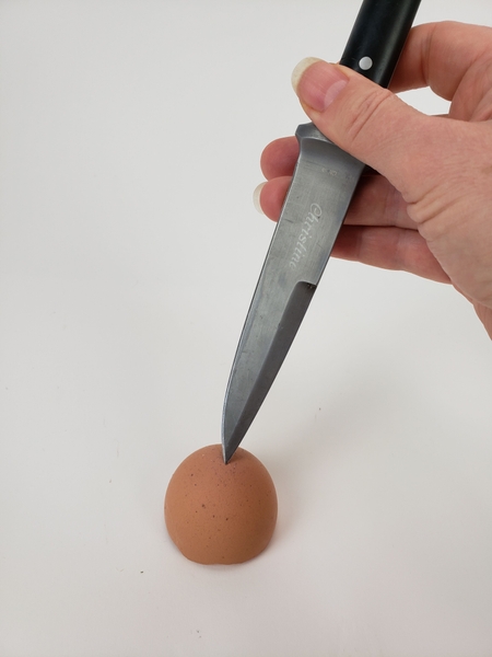 Make a hole in the bottom of an eggshell Make a hole in the bottom of an eggshell