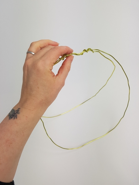 Secure the wire at one end to create the basket handle Secure the wire at one end to create the basket handle