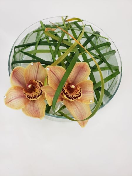 Cymbidium and lily grass flower arrangement Cymbidium and lily grass flower arrangement