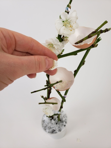 Scatter a few blossom petals into the eggshells Scatter a few blossom petals into the eggshells