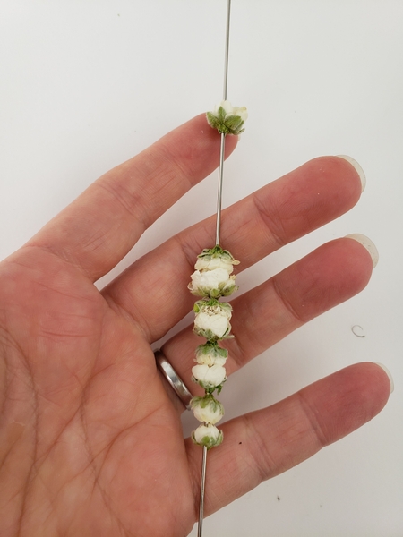 Thread in the largest blossom for the caterpillar head Thread in the largest blossom for the caterpillar head
