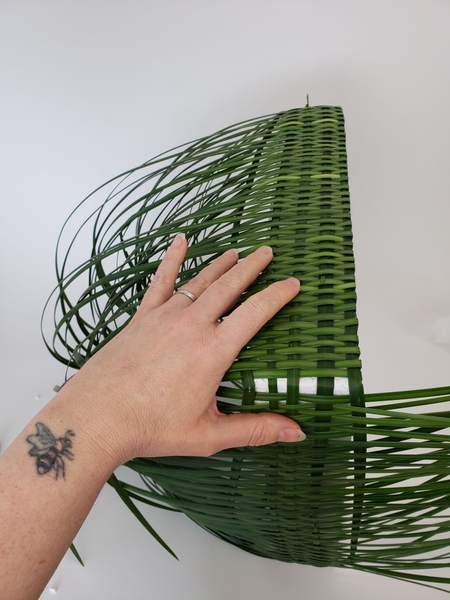Fold the grass over and pin it to the back Fold the grass over and pin it to the back