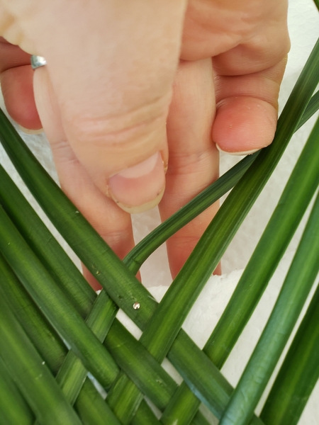 Pin the grass to keep it in place while you are weaving Pin the grass to keep it in place while you are weaving