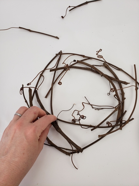 Shape the grapevine twigs to mimic the way a rose unfurls its petals Shape the grapevine twigs to mimic the way a rose unfurls its petals