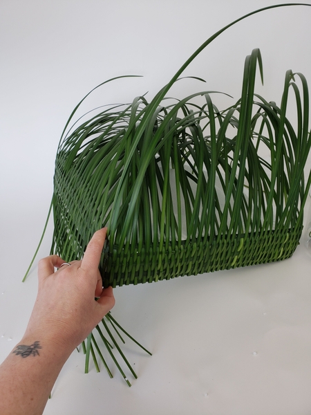 Wiggle the blades of grass and weave in grass if any gaps appear while securing the back Wiggle the blades of grass and weave in grass if any gaps appear while securing the back