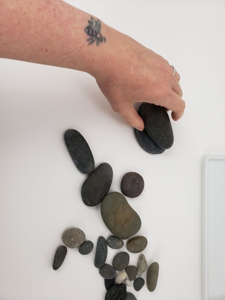 Pick a few pebbles that are easily stacked. Pick a few pebbles that are easily stacked.