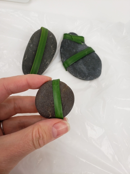 These bands makes it easier to interweave the grass to cover the pebbles These bands makes it easier to interweave the grass to cover the pebbles