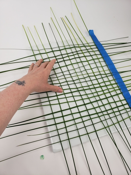 Weave a basic over and under patterned grass grid Weave a basic over and under patterned grass grid