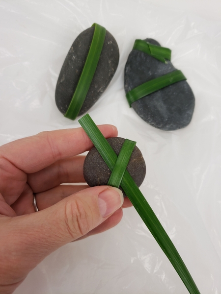 Weave a second blade of grass through the first and glue to secure Weave a second blade of grass through the first and glue to secure