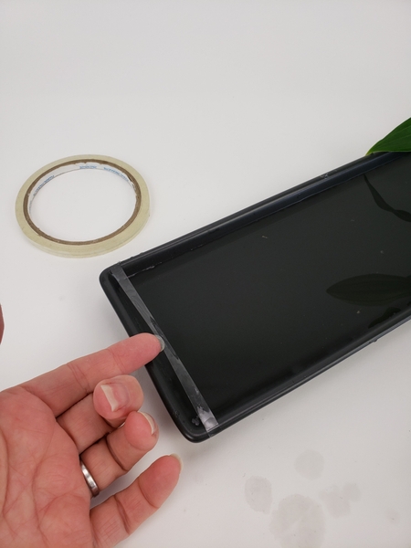 Wrap a thin strip of clear tape around the container Wrap a thin strip of clear tape around the container