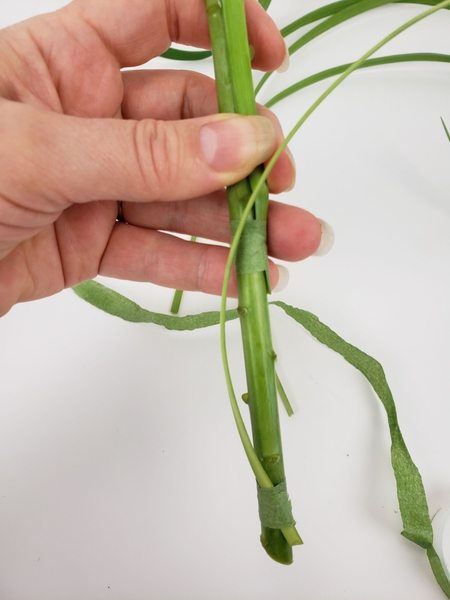 Bind a second blade of grass to the flowers stem Bind a second blade of grass to the flowers stem