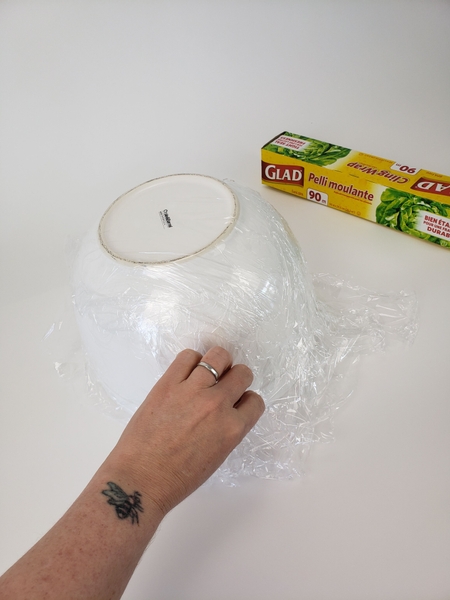 Cover a large mixing bowl with plastic wrap Cover a large mixing bowl with plastic wrap
