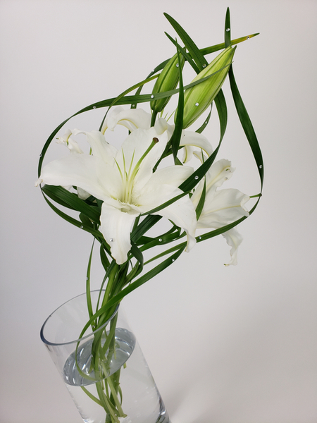 Floral design with a single lily stem