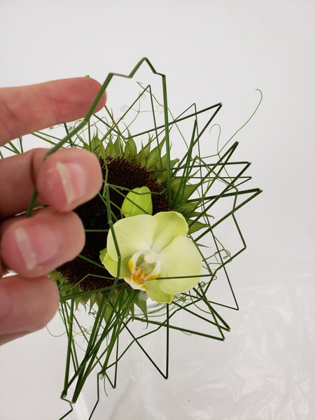 Let the blades of grass drape over the design Let the blades of grass drape over the design