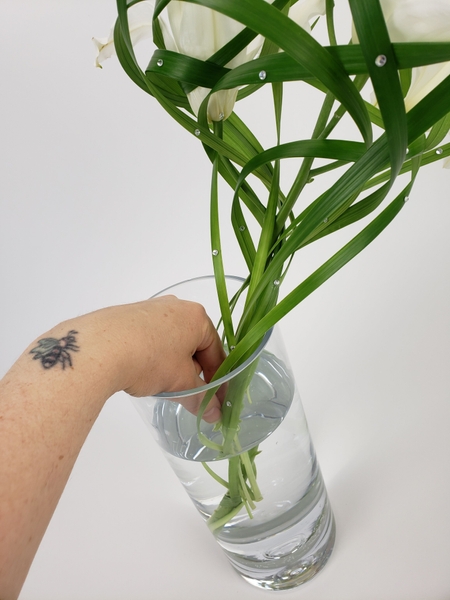 Slip any grass stems deeper so that the design can remain hydrated for as long as possible Slip any grass stems deeper so that the design can remain hydrated for as long as possible