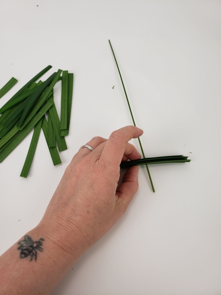 Thread the lily grass sections into the flexi grass Thread the lily grass sections into the flexi grass