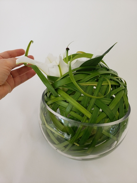 Allow the grass curls to naturally fall over the lily Allow the grass curls to naturally fall over the lily