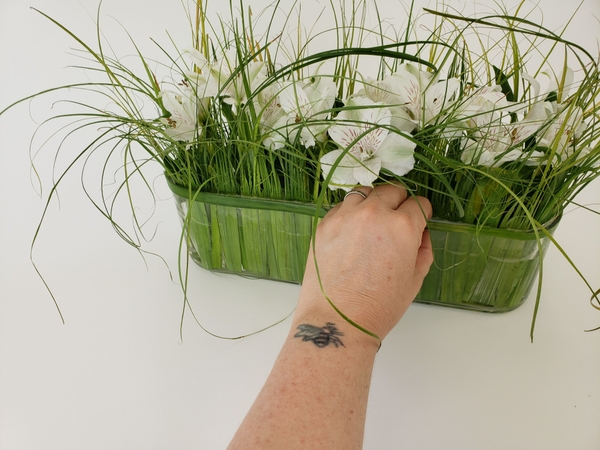 Complete the design by adding a band of foliage to conceal the tape Complete the design by adding a band of foliage to conceal the tape