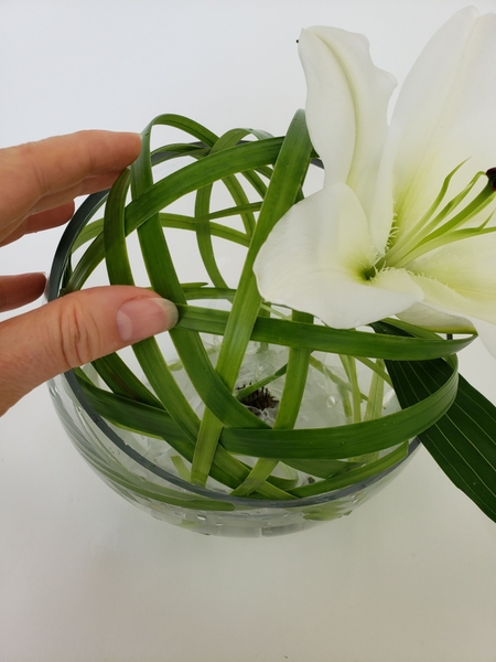 Spin the container so that you weave grass in from all angles