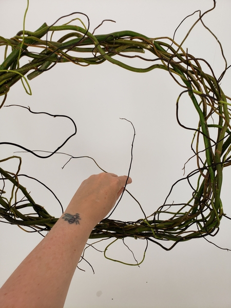Add in a few thinner twigs where you see gaps so that the wild willow tips extend all around the wreath Add in a few thinner twigs where you see gaps so that the wild willow tips extend all around the wreath