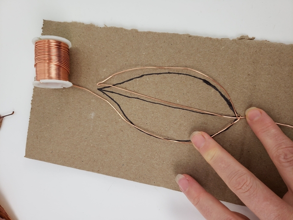 Curve the wire back up following the outlines of the template Curve the wire back up following the outlines of the template