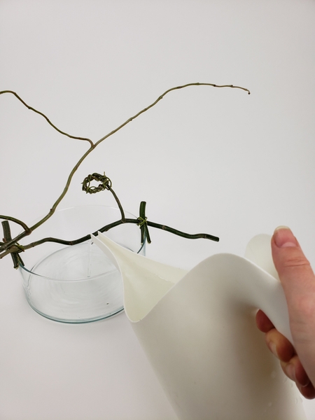 Fill the container with water so that the flower stem will remain hydrated Fill the container with water so that the flower stem will remain hydrated
