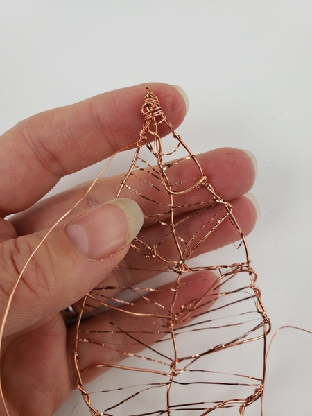 Frame the leaf by wrapping the edge with a thinner copper wire Frame the leaf by wrapping the edge with a thinner copper wire