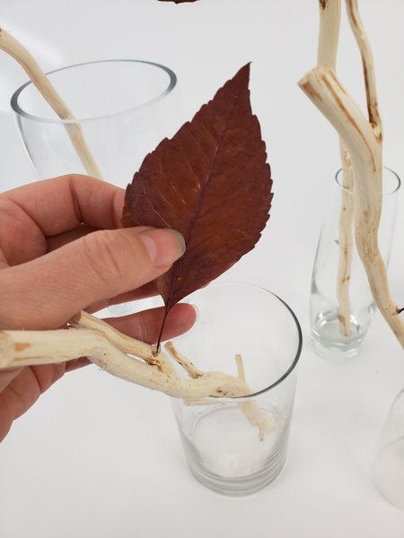 Hold the leaf in position for the glue to set Hold the leaf in position for the glue to set