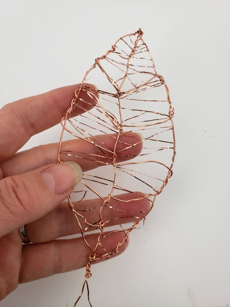 I simply wove the flat copper wire in and out and around the leaf I simply wove the flat copper wire in and out and around the leaf