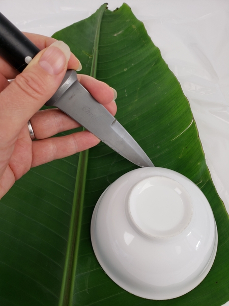 Place a small bowl on the leaf and cut a disk out with a sharp knife Place a small bowl on the leaf and cut a disk out with a sharp knife