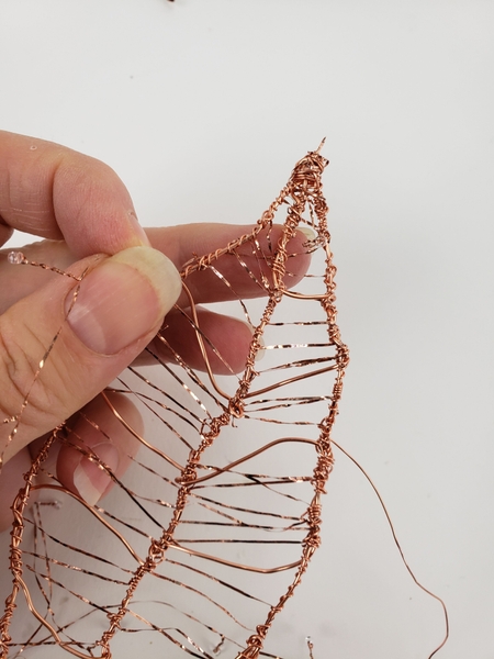 Twist the beaded wire to secure it to the frame Twist the beaded wire to secure it to the frame