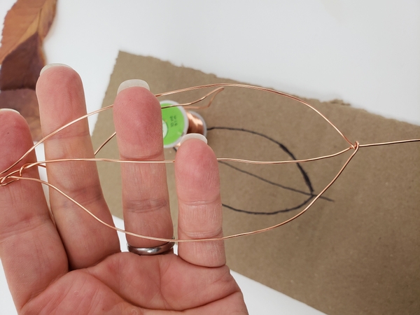 Twist the wire around the tip of the leaf to secure Twist the wire around the tip of the leaf to secure