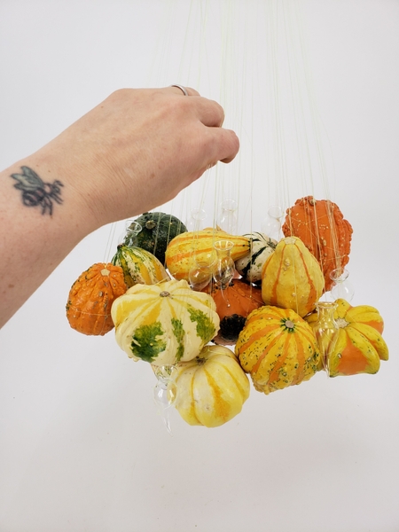 Hang the vases between the pumpkins