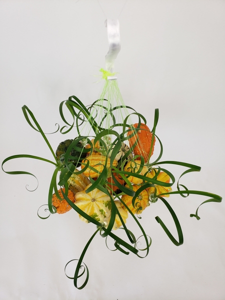 Hanging pumpkins in a flower arrangement by Christine de Beer Hanging pumpkins in a flower arrangement by Christine de Beer