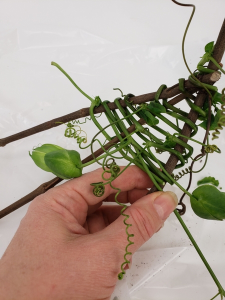 My vine still had a few flower buds on it and I simply wove them into the basket