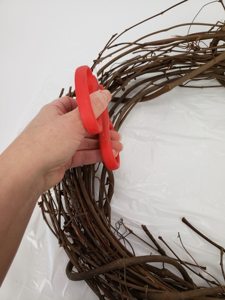 Simply snip the vine on both sides and pull it out of the wreath